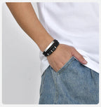 Steel engraved bracelet worn with jeans and a white t-shirt