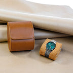Brown 1-watch roll with a steel watch on its pillow
